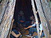 The kids inside a wooden teepee