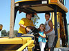 Tyler, Jordan, and Dakota playing on Ken's tractor