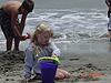 Catelyn putting sand in a bucket