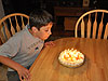 Tyler blowing out the candles on his birthday pie