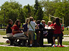 Some parents and students relaxing at a picnic table