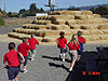 The kids running to go play on the haystack