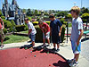 The boys playing miniature golf
