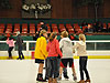The girls talking in the center of the rink