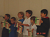 The kids holding up their certificates