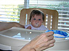 Jordan eating for the first time in her highchair