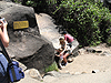 Tanya helping Jordan climb up the rocks with Tyler